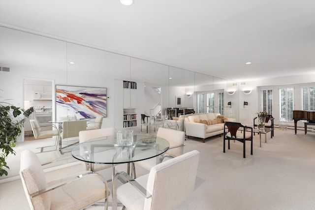 dining area with recessed lighting, visible vents, and light colored carpet