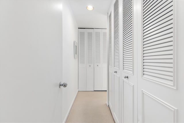 corridor featuring recessed lighting, light carpet, visible vents, and baseboards