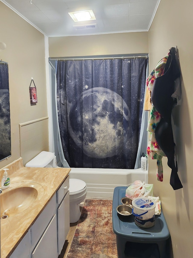 full bathroom featuring vanity, ornamental molding, shower / bath combo with shower curtain, and toilet