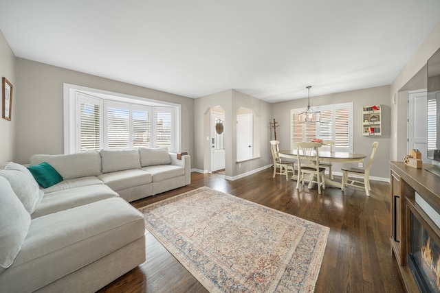 living room featuring dark hardwood / wood-style flooring and a chandelier