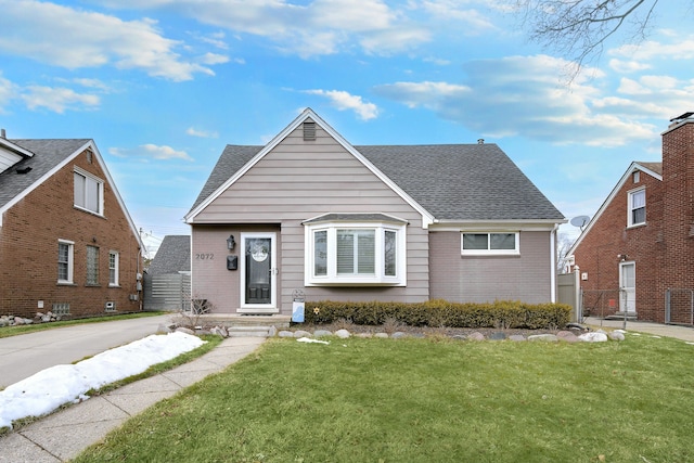 bungalow-style house featuring a front lawn