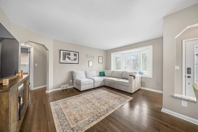 living room featuring dark wood-type flooring