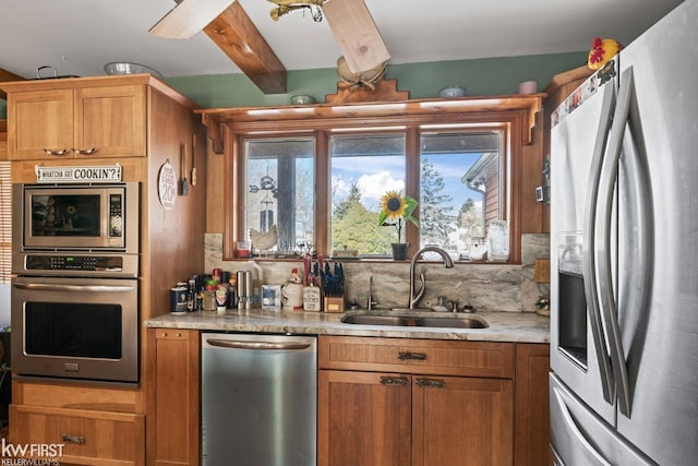 kitchen with stainless steel appliances, sink, beam ceiling, and decorative backsplash