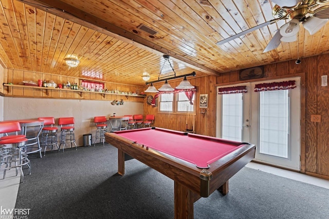 playroom featuring wooden walls, bar area, carpet floors, and wooden ceiling