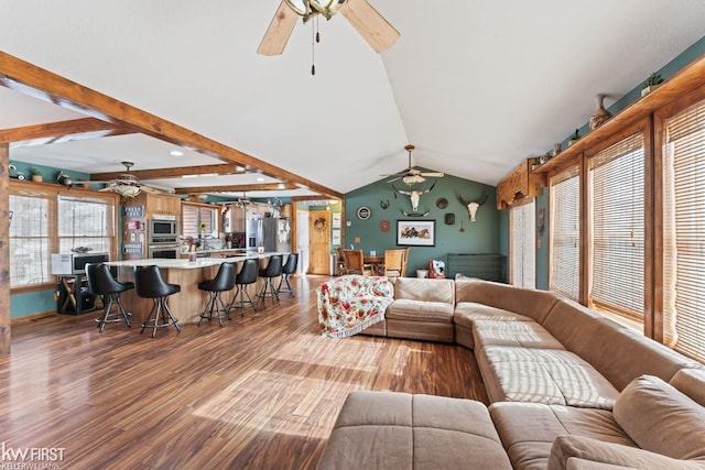 living room with vaulted ceiling with beams, wood-type flooring, and ceiling fan