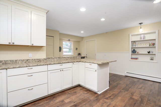 kitchen with light stone counters, decorative light fixtures, kitchen peninsula, and white cabinets