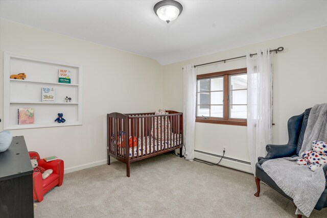 carpeted bedroom featuring a baseboard radiator and lofted ceiling