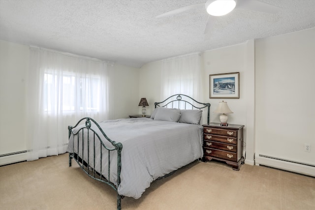 carpeted bedroom featuring ceiling fan, a textured ceiling, and a baseboard heating unit