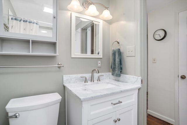 bathroom featuring vanity and toilet