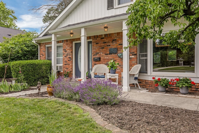 view of exterior entry featuring covered porch