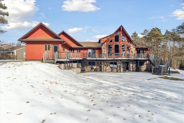 snow covered property with a deck