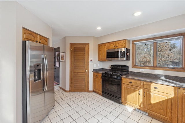 kitchen featuring stainless steel appliances and light tile patterned floors