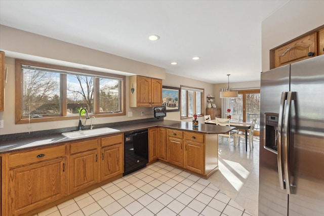 kitchen with pendant lighting, sink, stainless steel fridge, black dishwasher, and kitchen peninsula