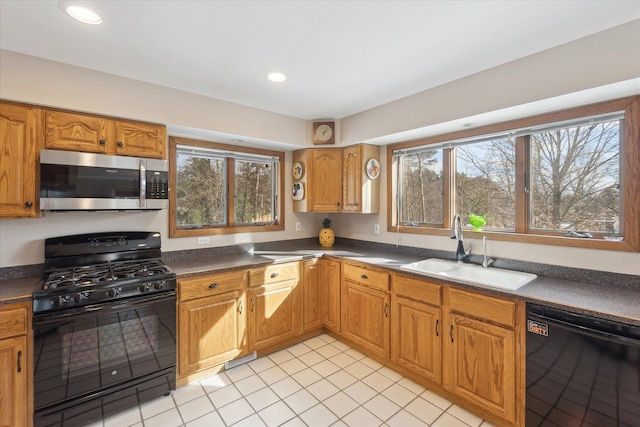 kitchen with sink, light tile patterned floors, and black appliances