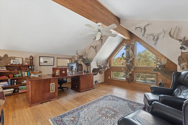 home office with ceiling fan, vaulted ceiling with beams, and light hardwood / wood-style floors