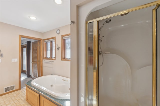 bathroom featuring shower with separate bathtub