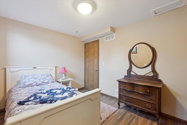 bedroom with dark hardwood / wood-style flooring