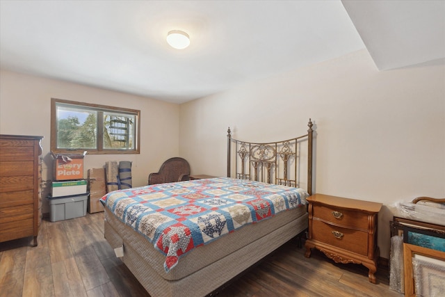 bedroom with dark hardwood / wood-style floors