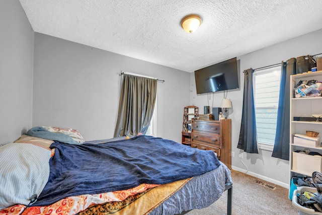 carpeted bedroom with a textured ceiling