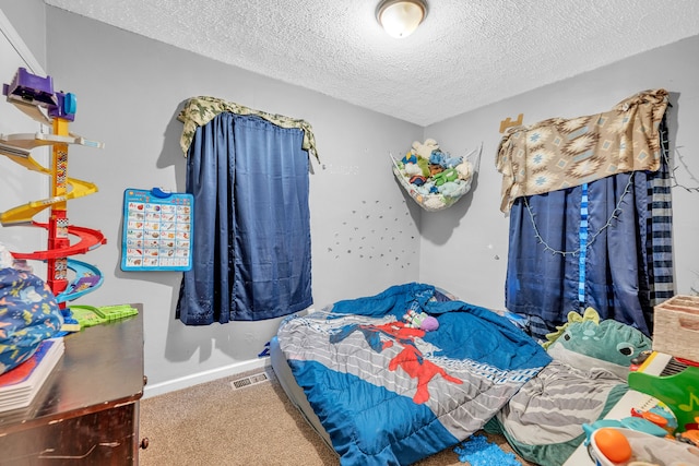 bedroom with carpet flooring and a textured ceiling