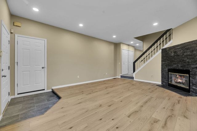 unfurnished living room with hardwood / wood-style floors and a fireplace