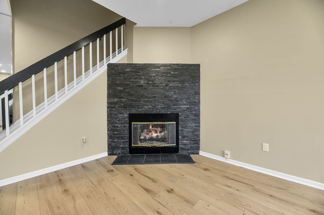 unfurnished living room with wood-type flooring and a fireplace