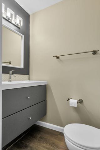 bathroom featuring vanity, toilet, and wood-type flooring