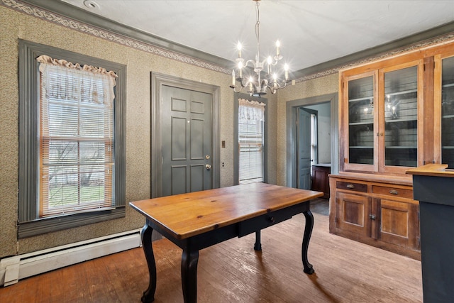 dining space with baseboard heating, ornamental molding, light hardwood / wood-style floors, and a notable chandelier