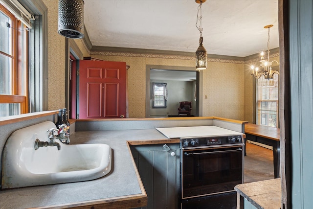 kitchen with pendant lighting, sink, crown molding, black range with electric stovetop, and an inviting chandelier