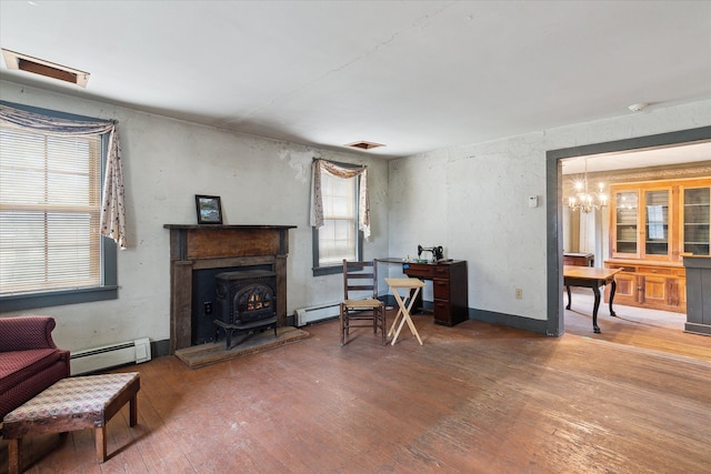 interior space featuring a baseboard heating unit, hardwood / wood-style floors, and a notable chandelier