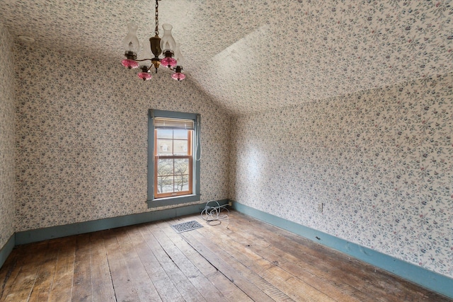 additional living space with lofted ceiling and hardwood / wood-style flooring