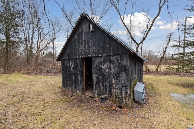 view of outbuilding with a yard