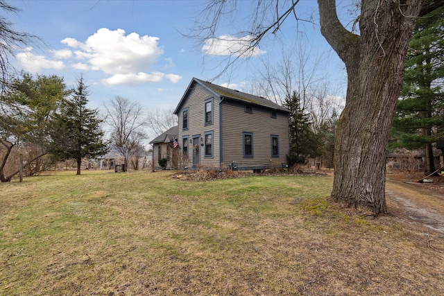 view of property exterior with a lawn