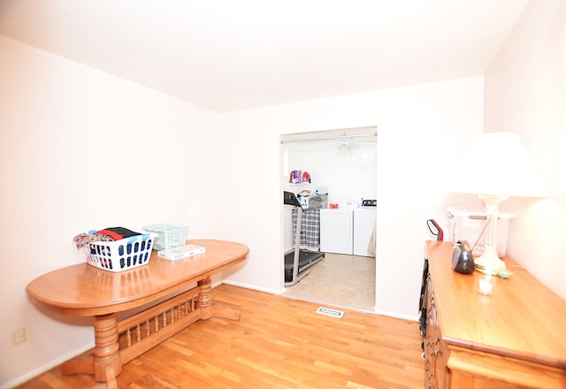 interior space featuring hardwood / wood-style floors and washing machine and clothes dryer