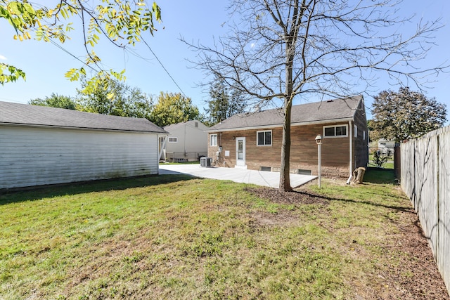 back of house featuring a patio, a fenced backyard, central AC, crawl space, and a lawn