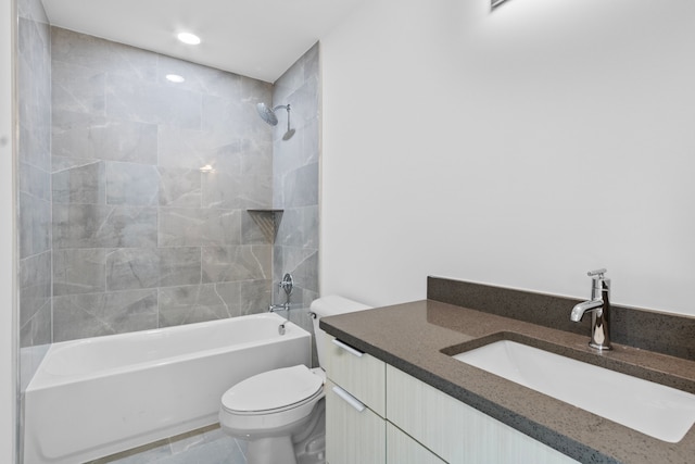 full bathroom with vanity, tiled shower / bath, and toilet