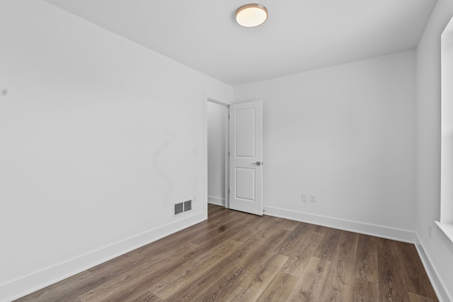 spare room featuring wood-type flooring