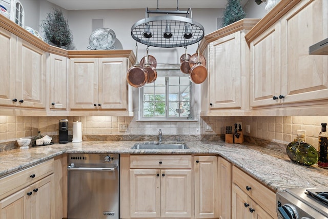 kitchen featuring sink, stove, light stone countertops, and light brown cabinetry