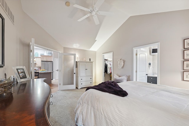 carpeted bedroom with a closet, ensuite bath, a spacious closet, stainless steel fridge, and high vaulted ceiling