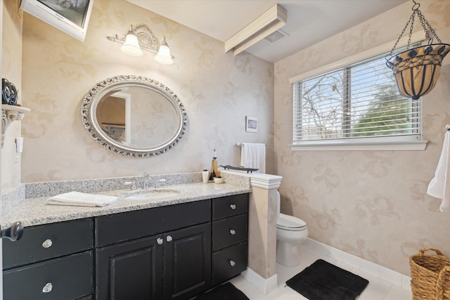 bathroom with vanity, toilet, and tile patterned floors