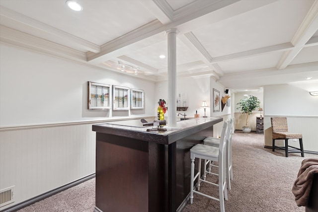 kitchen with beam ceiling, carpet floors, coffered ceiling, a kitchen island, and decorative columns