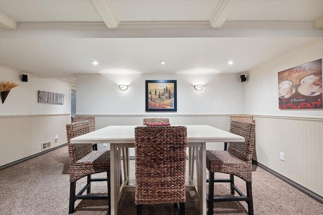 dining room featuring crown molding, carpet flooring, and beam ceiling