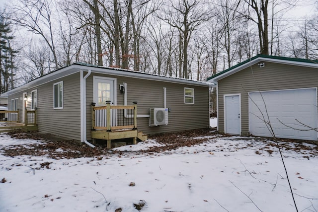 view of front of home featuring a garage, an outdoor structure, and ac unit