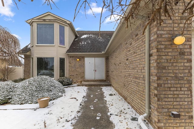 view of snow covered property entrance