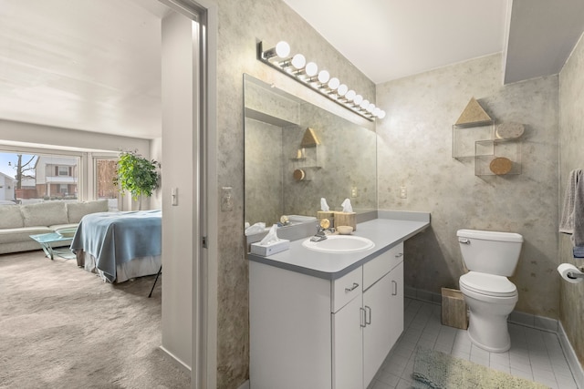 bathroom featuring vanity, tile patterned flooring, and toilet