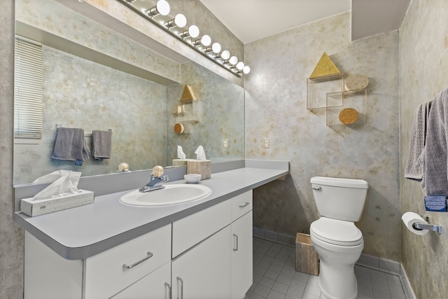 bathroom with vanity, toilet, and tile patterned flooring