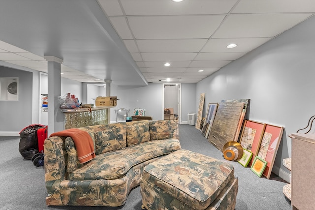 carpeted living room with a paneled ceiling