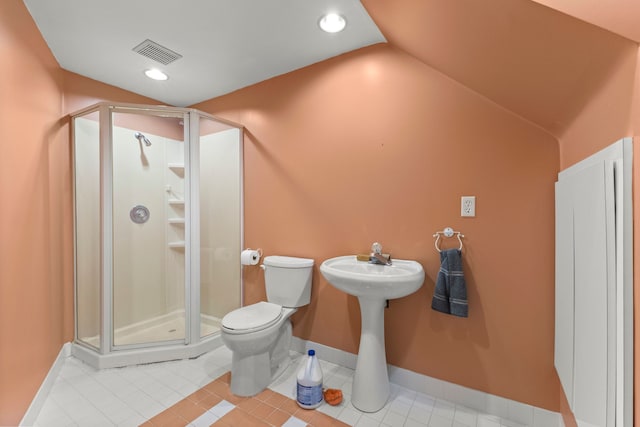 bathroom featuring lofted ceiling, toilet, an enclosed shower, and tile patterned flooring