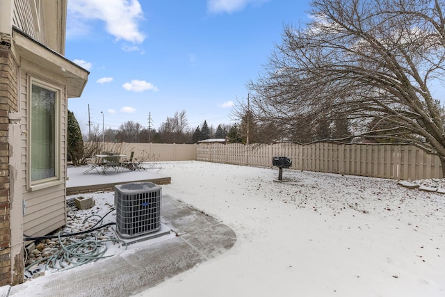 yard covered in snow with cooling unit