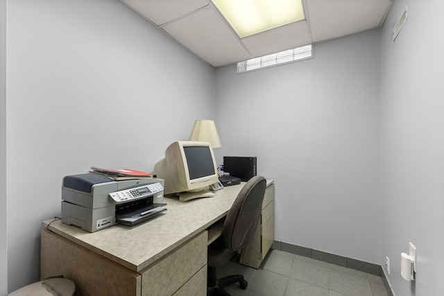 tiled office featuring a drop ceiling